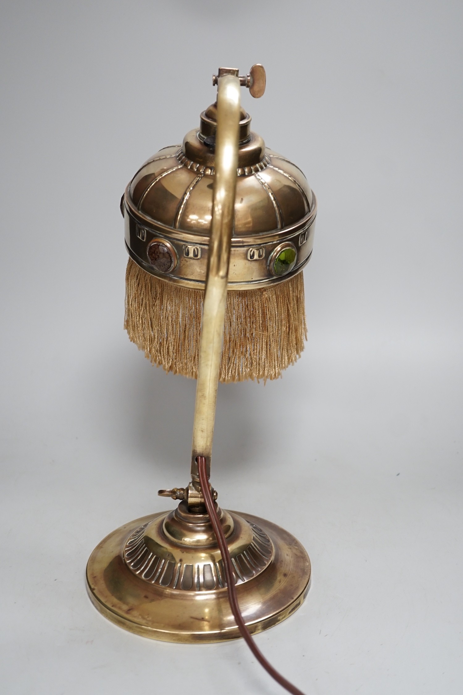 An adjustable Arts and Crafts brass and ‘jewelled’ table lamp, 34cm